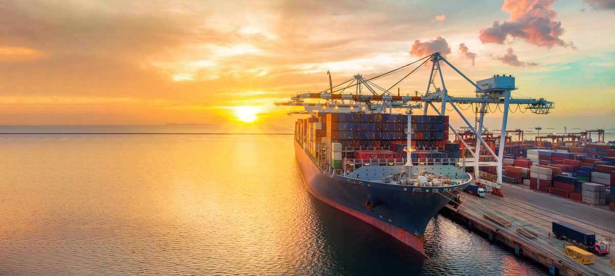Port crane handling containers for freight forwarding